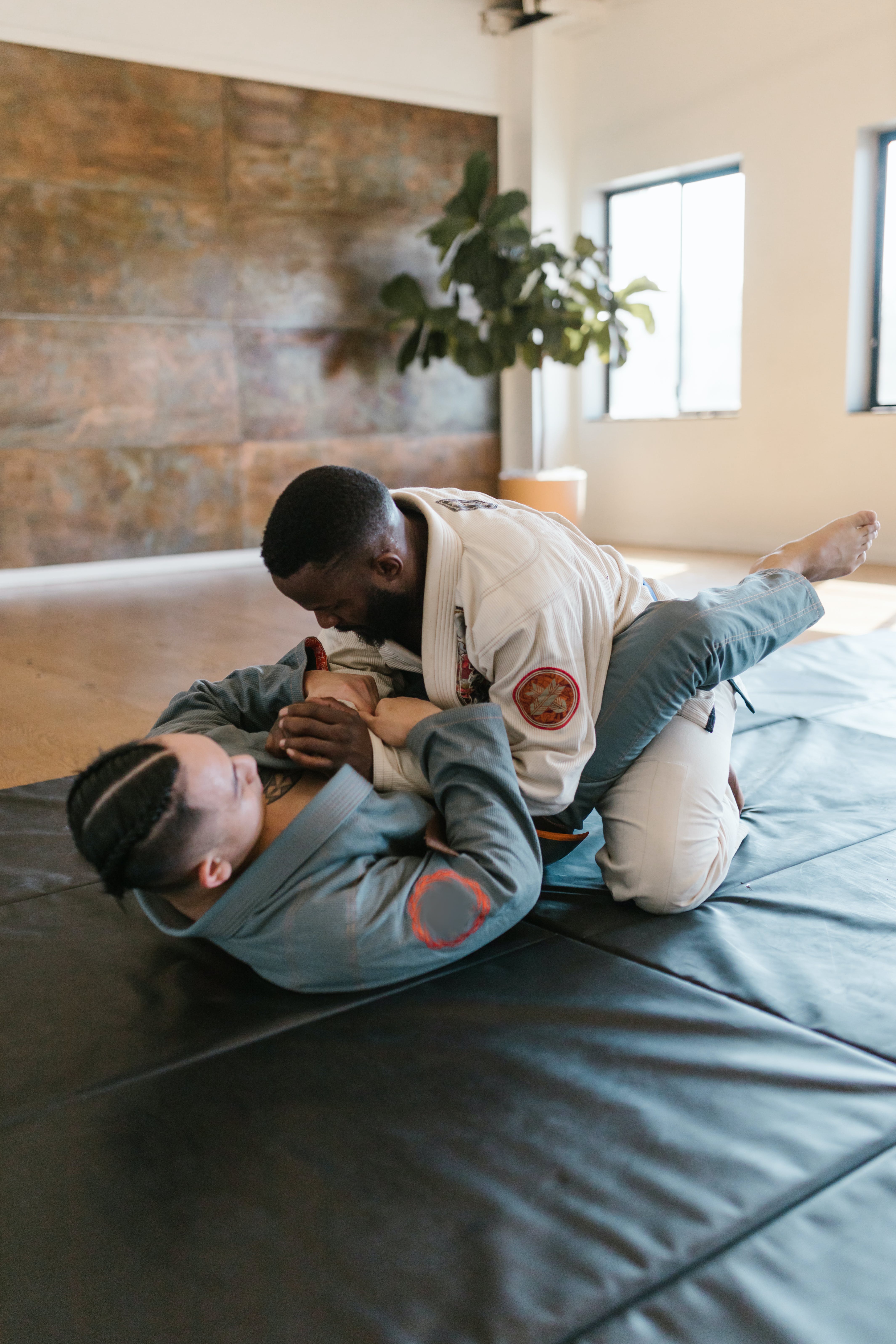 Two men engaged in closed guard.